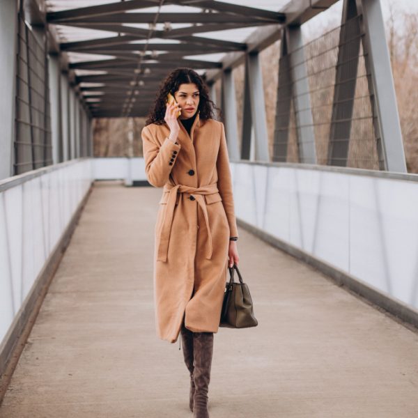 woman-beige-coat-walking-city